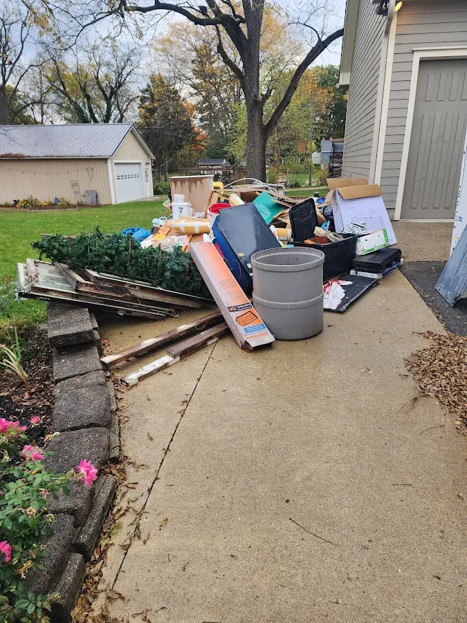 Dumpster being loaded with debris for 12 Yard Dumpster Rental in Jupiter Farms